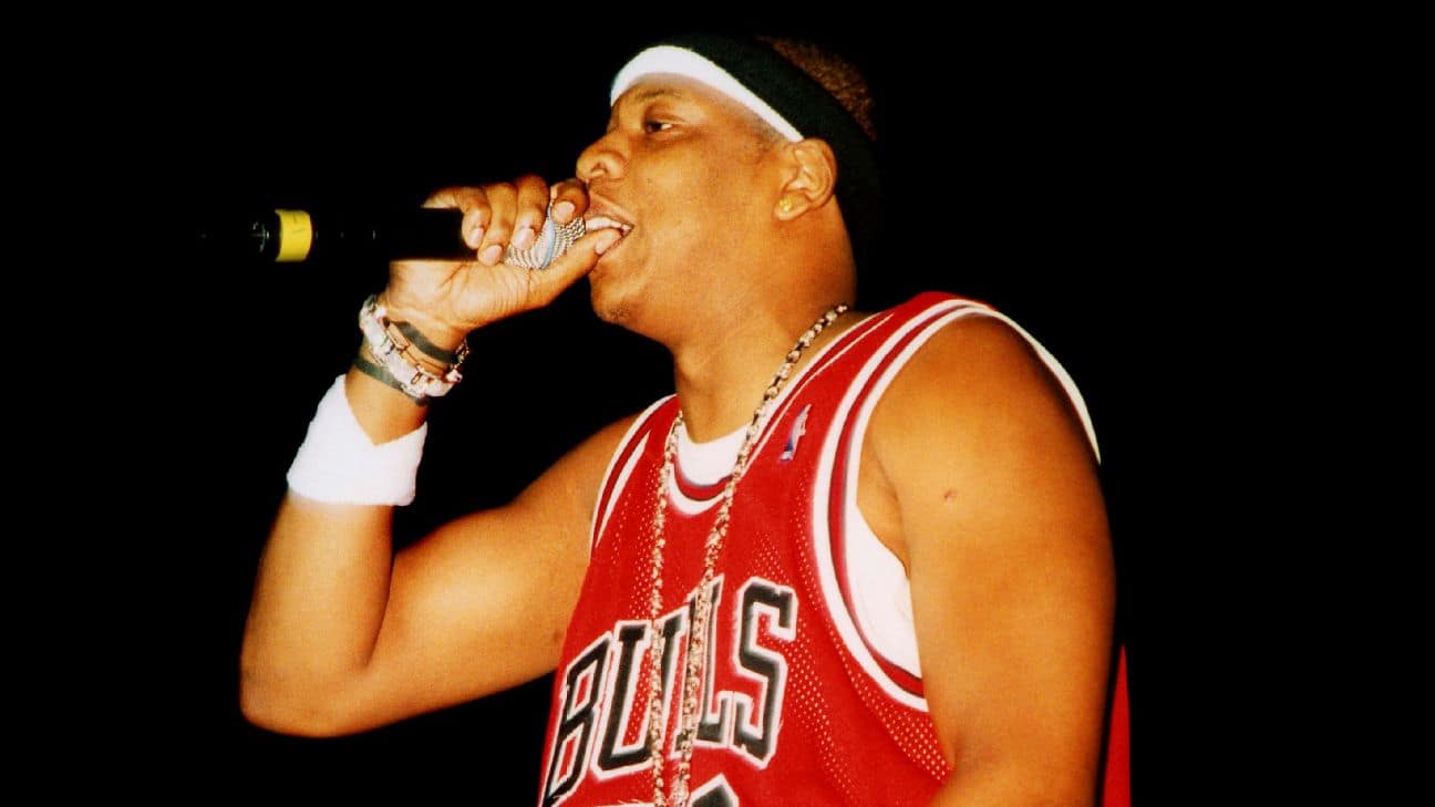 Jay-Z, aka Hov, being captured performing while in a Micheal Jordan Jersey, relevant to the legendary NBA run MJ was on at the time.